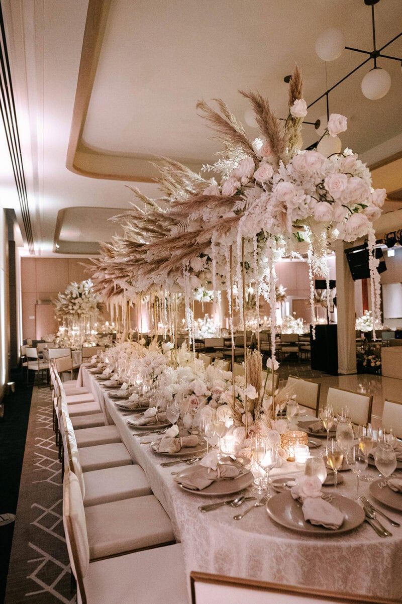 Elegant floral centerpiece with white and blush flowers for wedding decor.
