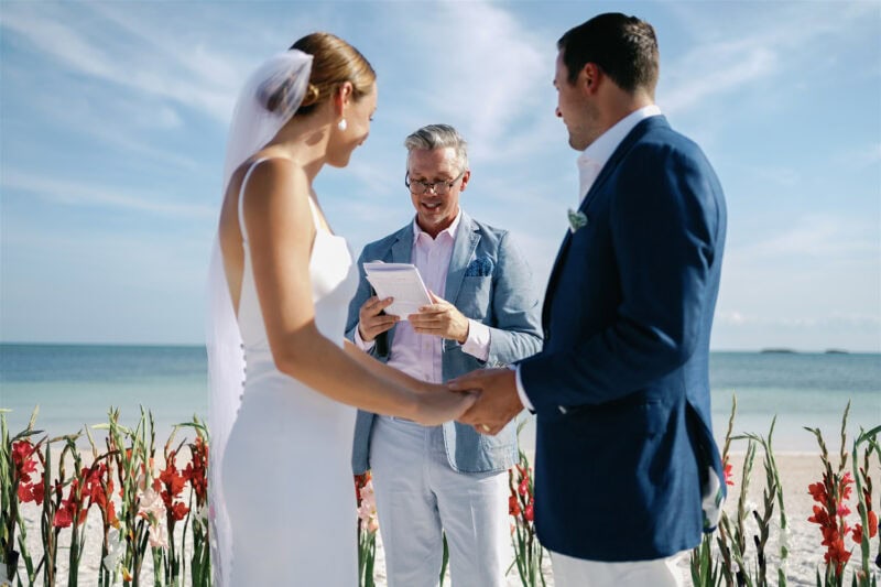 Wedding ceremony on the beach with Babbie & Jamie exchanging vows.