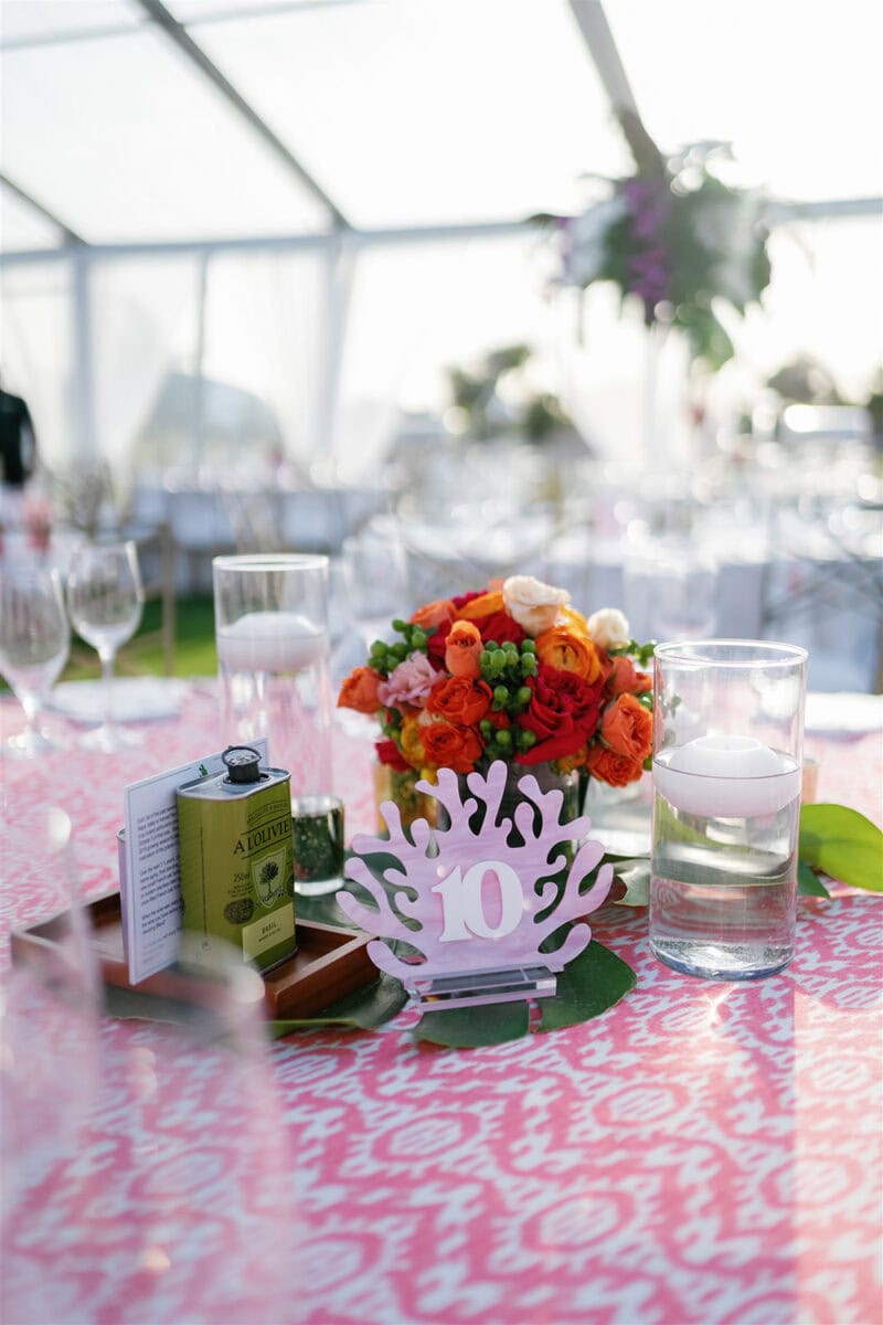 Beautiful floral centerpiece with orange and white flowers at a wedding reception.