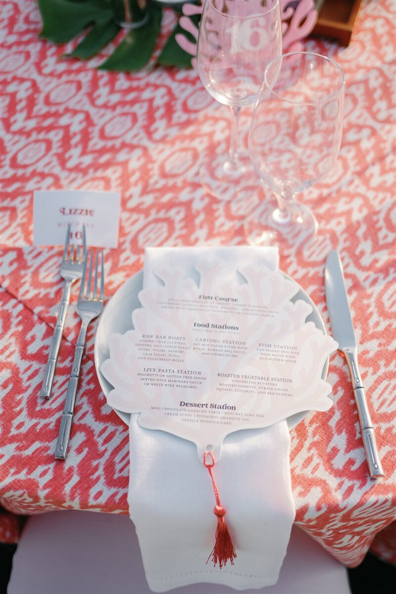 Beautiful wedding table setup with menu card, champagne glasses, and floral accents.