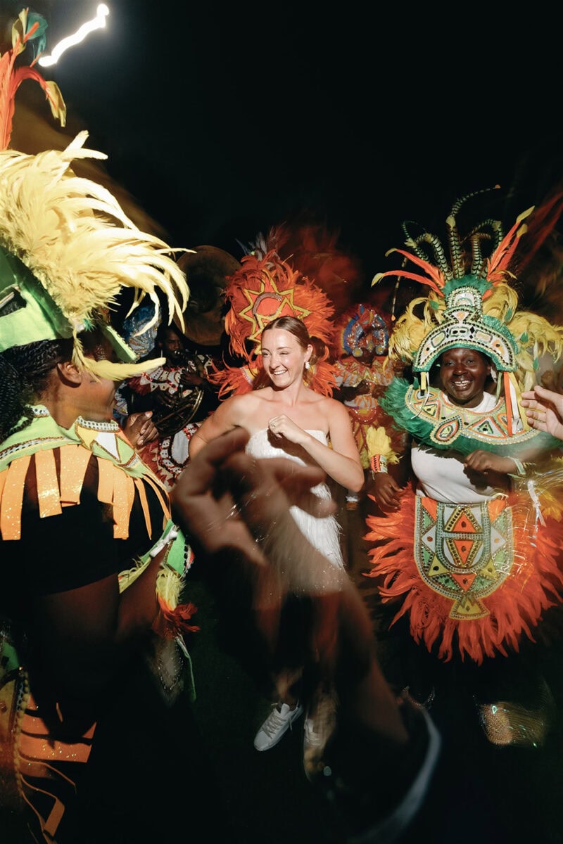 Vibrant dancers in colorful costumes perform at Babbie & Jamie wedding celebration.