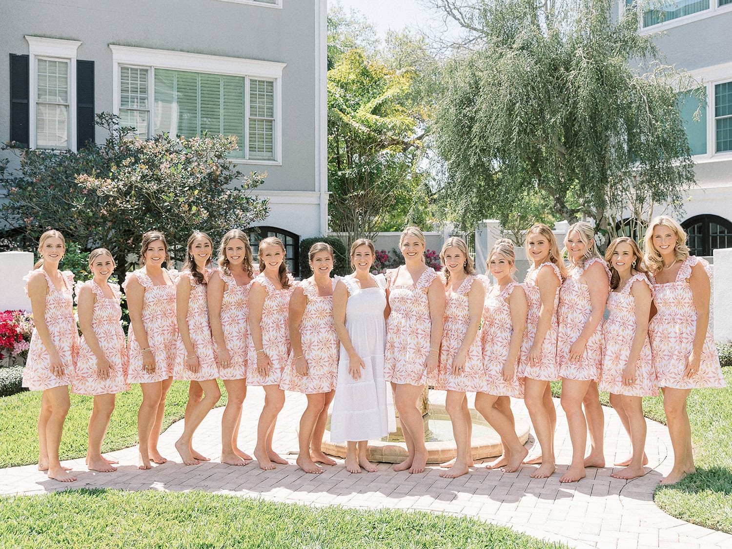 Group of bridesmaids and bride outdoors, ready for wedding photos.