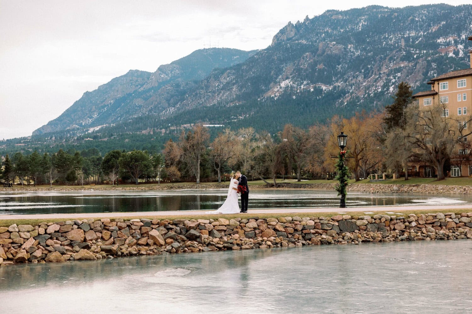 Bride and groom standing by the water, showcasing the wedding planning process.