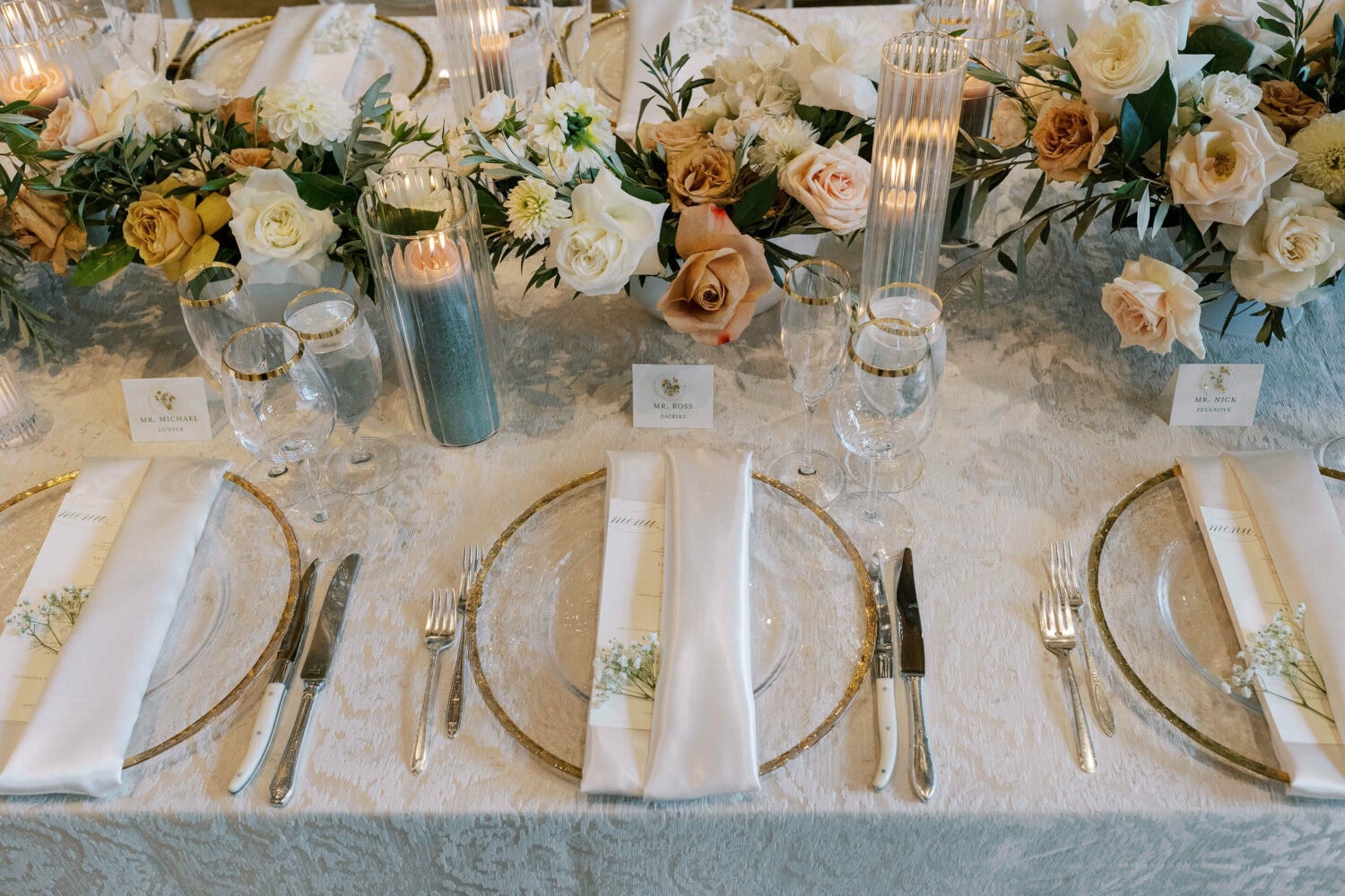 Elegant wedding table with floral centerpiece and sophisticated place settings.