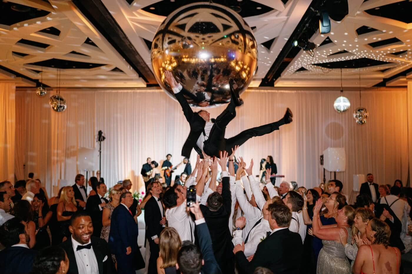 Vibrant dance troupe performing at a wedding reception.