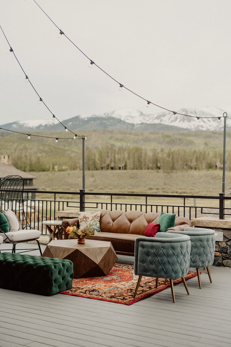 Outdoor wedding lounge with stylish seating and string lights.