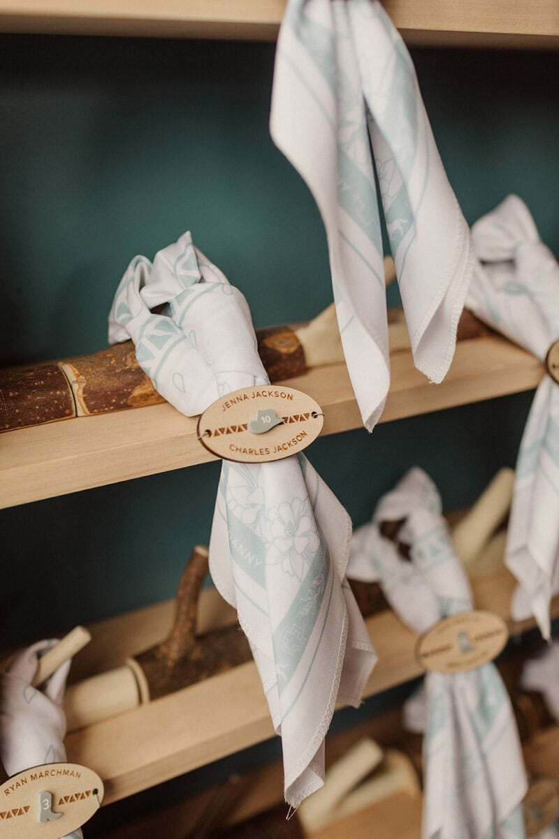 Elegant white napkins with personalized wooden tags for Taylor & Danny's wedding.