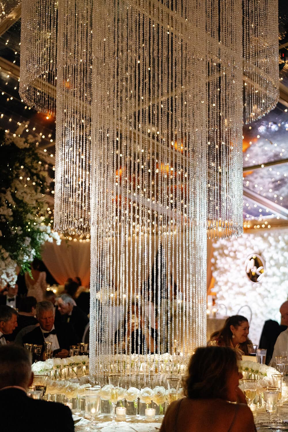 Chandelier centerpiece with hanging crystals at a Colorado wedding reception.